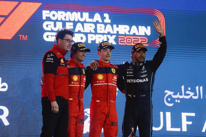 Lewis Hamilton op het podium geflankeerd door zijn toekomstige teamgenoot Charles Leclerc.